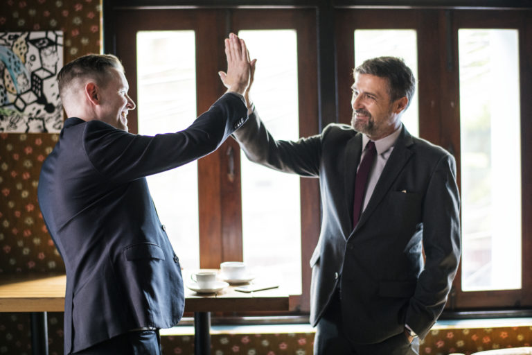 Businessmen giving a high five
